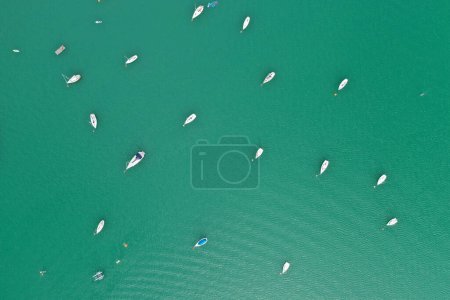 Photo for Captured by drone, a fleet of sailboats scatter across the teal waters of a mountain lake in Slovenia, inviting a sense of adventure and discovery in this breathtaking scene. - Royalty Free Image