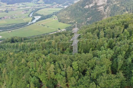 Photo for Overlooking an Austrian Alpine valley, the power grid stands as a testament to human ingenuity amidst natural splendor, in a landscape brought to life by drone photography. - Royalty Free Image