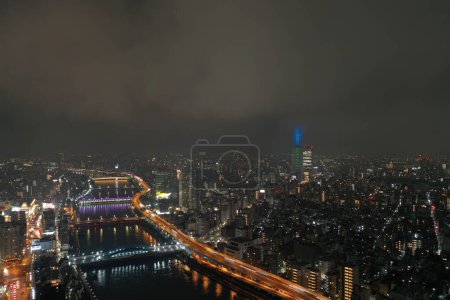 Photo for Tokyo's landscape is bathed in an ethereal glow, where the meandering river reflects the city lights, captured from above by a drone. This image is a testament to Tokyo's harmonious blend of natural and urban elements, inviting viewers to explore the - Royalty Free Image
