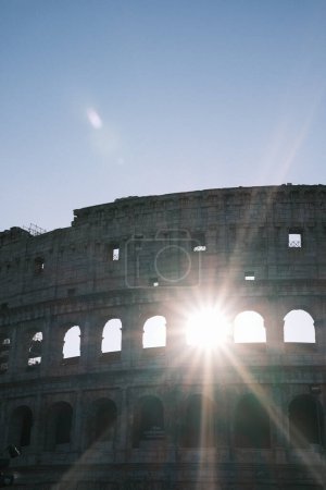 Sunlight streams through the Colosseum, illuminating the enduring grandeur of an arena that has stood the test of time in Rome.