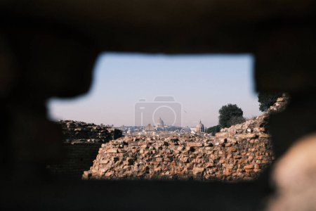 Photo for From the midst of Roman ruins, the Vatican stands in the distance, a historic beacon in the city of Rome. This view encapsulates the enduring spirit of an empire and the enduring faith that has shaped history. - Royalty Free Image