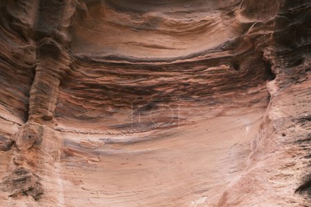 This captivating close-up of sandstone layers reveals the textured patterns and rich earthy tones that make up the Jordanian canyons, a testament to the natural artistry of geological processes.