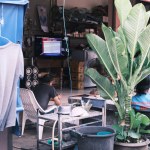 A glimpse into the daily life on the streets of Phuket, with local shops reflecting the vibrant culture and community of Thailand.