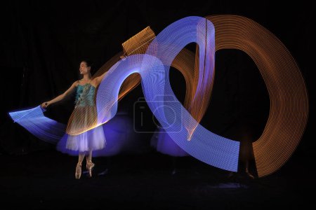Photo for Beautiful Ballerina Dancing with light in Jakarta Indonesia, Shot in several lights to get a unique lighting movement. 12 06 2022 - Royalty Free Image