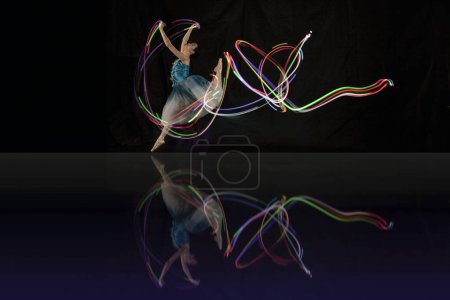 Photo for Beautiful Ballerina Dancing with light in Jakarta Indonesia, Shot in several lights to get a unique lighting movement. 12 06 2022 - Royalty Free Image