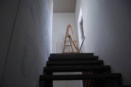 Stairs to the second floor.Construction work in a private house. Natural lighting of a flight of stairs.