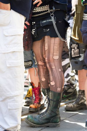 Téléchargez les photos : Jambes de jeune femme avec des bas déchirés et des bottes lourdes le 1er mai Rallye - en image libre de droit