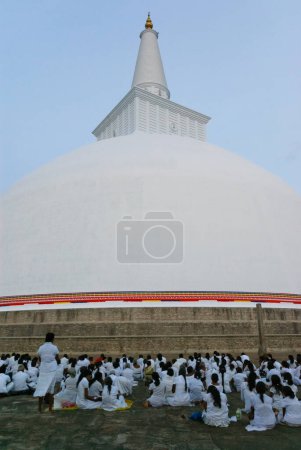 Photo for Buddhists gathered at the Ruwanwelisaya Stupa in Anuradhapura - Royalty Free Image
