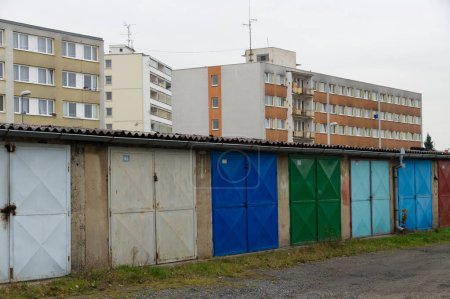 Weathered garages by communist style prefabricated concrete apartment houses