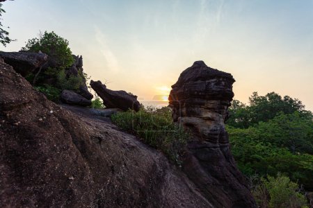 Photo for Scenery sunrise at weird shaped rock.These stones have been meticulously formed by nature to create a stunning visual masterpiece.The stones had been carved and shaped into incredible structures. - Royalty Free Image