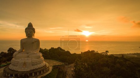 Photo for Aerial view Phuket big Buddha in beautiful sunset.amazing sun shines through the yellow clouds impact on golden sea surfaceThe beauty of the statue fits perfectly with the charming nature. - Royalty Free Image