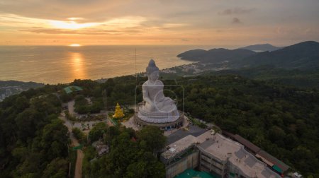 Photo for Aerial view Phuket big Buddha in beautiful sunset.amazing sun shines through the yellow clouds impact on golden sea surfaceThe beauty of the statue fits perfectly with the charming nature. - Royalty Free Image