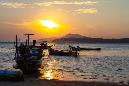 Photo for Amazing yellow sky of sunrise above the island, fishing boats parking on the golden sea - Royalty Free Image