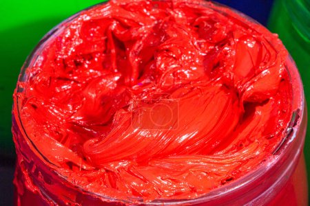 Photo for Close up red color of ink for print tee shirt in the transparent glass bucket - Royalty Free Image