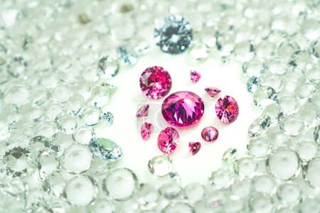Photo for Pink gemstones is displayed on a white background swirling around.Pink diamonds of various sizes and shapes are displayed in the middle of white diamonds.Sweet pink diamonds.white gems background - Royalty Free Image