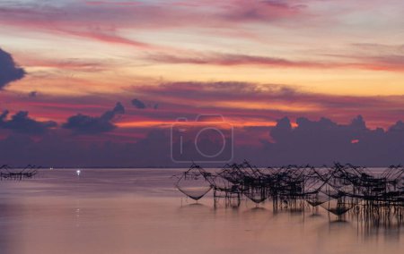 Téléchargez les photos : Incroyable ciel coloré au lever du soleil au-dessus du piège à pêche à Pakpra, Thaïlande - en image libre de droit