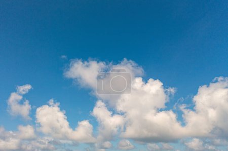 Photo for .The sky was a brilliant blue, dotted with white clouds that moved gracefully across the horizon..The wind gently blew them to and fro, seemingly without direction. .abstract sky nature background. - Royalty Free Image
