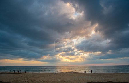 Photo for Stunning clouds float above the sea as the sun sets - Royalty Free Image