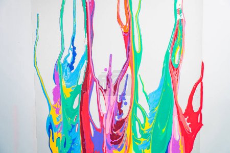 Photo for Flowing multicolored paint on white, painted abstract background - Royalty Free Image