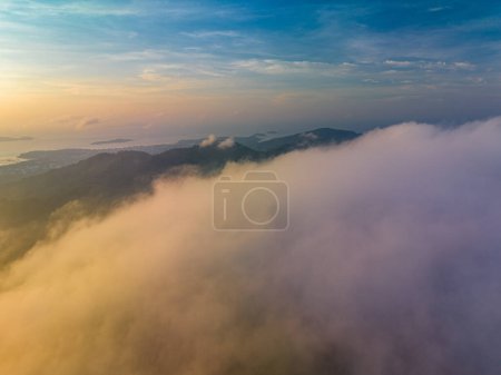 Foto de Aerial view The Big Buddha of Phuket can only be seen as the head peeking out from the sea of mist..Phuket Big Buddha in the thick white mist. .A fluffy mist covers the Big Buddha in Phuket. - Imagen libre de derechos