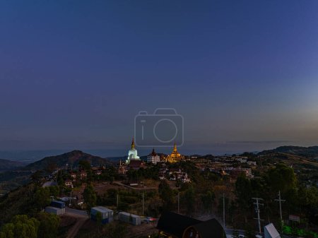 Photo for Aerial view amazing Big White Five buddha Statues in sunset. beautiful golden pavilion of Wat Phachonkeaw decorate with jewels and stones on the hill very beautiful and famous landmark in Thailand. - Royalty Free Image