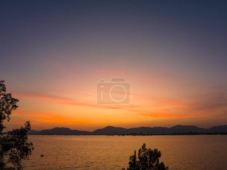 Photo for Orange sky at sunset above Khao Khad viewpoint Phuket. Beautiful The glare of the sun shone through the mangroves. Reflections of the sun in the mangroves on the seaside of the mangroves. - Royalty Free Image