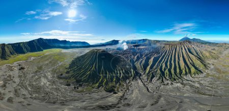 Aerial panorama view Bromo volcano constantly spews white smoke from its crater