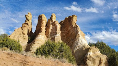 Photo for This photo showcases the towering, colorful rock pinnacles found in New Mexico. The unique formations, created by erosion, are a testament to the majesty of nature. The blue sky and clouds provide a stunning backdrop to this awe-inspiring landscape. - Royalty Free Image