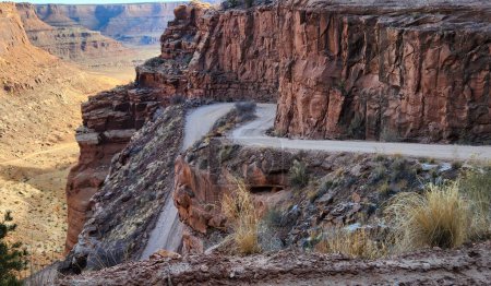 Photo for This stunning photo captures the rugged beauty of Shafer Switchbacks in Moab, Utah. The winding road cuts through the red rock canyon, offering breathtaking views of the desert landscape. - Royalty Free Image