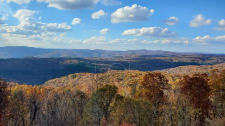Photo for This breathtaking photo captures the majesty of the Ozark Mountains in Arkansas. The autumn foliage creates a stunning contrast against the blue sky and rolling hills. - Royalty Free Image