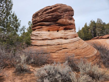 Photo for A unique rock formation that looks like a big thimble in southern Utah. The formation is made of red sandstone and is surrounded by desert flora and a blue sky. - Royalty Free Image