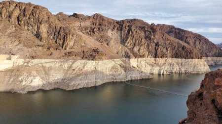 Photo for This photo shows the alarming effects of the drought on the Hoover Dam and Lake Mead in November 2022. The water level has dropped to a historic low, revealing the canyons sediment and geology. - Royalty Free Image