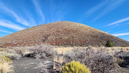 Photo for This photo captures the stunning view of Maroon Crater, an extinct volcano in Arizona. The volcanic cinder cone rises in the background, showcasing the geology and history of this scenic area. - Royalty Free Image