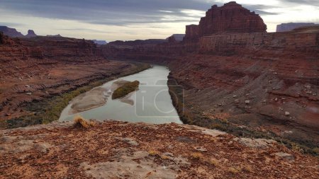 Photo for The winding Colorado River cuts through the red rock canyon in Moab, Utah, creating a breathtaking landscape that is a must-see destination for nature lovers and adventurers. - Royalty Free Image