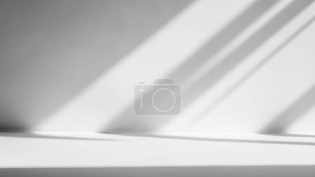 Photo for Dynamic Light and Shadow Play on Minimal White Studio Background - Royalty Free Image