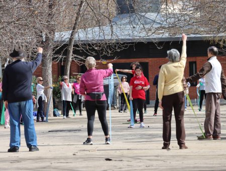Photo for Madrid - Spain - March 13, 2024.Outdoor physical activity for older people. Older adults doing exercise at Madrid Retiro park. - Royalty Free Image