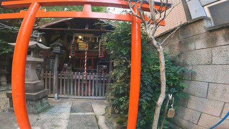 Photo for Shrine Taro Inari red torii approach shrine building.Japan, Tokyo, Asakusa. Taro Inari Shrine stands along the street in Asakusa - Royalty Free Image