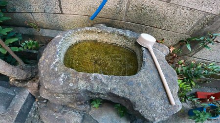 Photo for Chozusha Shrine Dipper Water Stone Pail Water Supply.Japan, Tokyo, Asakusa. Taro Inari Shrine stands along the street in Asakusa - Royalty Free Image