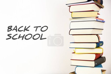 Back to school white vintage sign with many closed books isolated on blue background. 