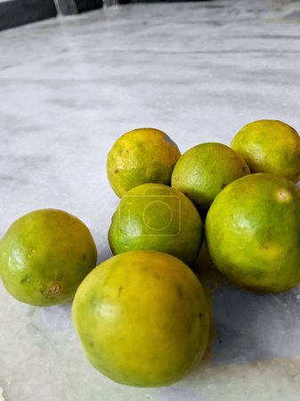 A closeup fresh green sweet lemons.