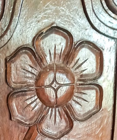 Ancient wood carving. Floral patterns on a wooden board.