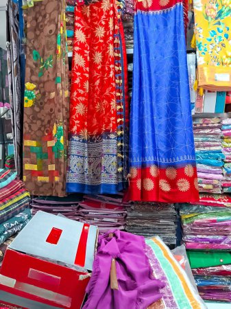Colorful Indian Saris hanging next to each other in shop.Traditional Indian dress, Different texture and color beautiful textile.