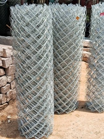 Photo for Metal Wire fence roll. Fencing rolled into rolls. Galvanized steel grating in stock. Fence with large cells. - Royalty Free Image