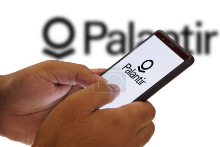 Photo for Person holding smartphone with logo of US software company Palantir Technologies Inc. on screen in front of website. Focus on phone displayDhaka, Bangladesh- 07 February 2024. - Royalty Free Image