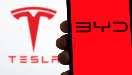 Photo for Selective focus of the BYD vs Tesla Logo on a mobile screen stock image. These companies are two electric vehicle makers giant in the world: Dhaka, Bangladesh- April 6, 2024 - Royalty Free Image