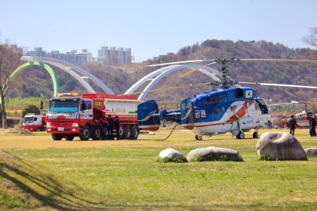 Photo for A Korean firefighting helicopter is captured mid-refueling at Taehwa Park, highlighting the critical role of aerial support in emergency services. - Royalty Free Image