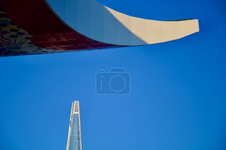 Photo for Seoul, South Korea - June 2, 2023: Detailed view of the World Peace Gate's up-tilted roof corner against a blue sky, with Lotte World Tower in the backdrop. - Royalty Free Image
