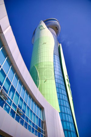 Photo for Hanam City, South Korea - October 1, 2023: Gazing up from the base of Hanam Union Tower, its grand structure stretches tall into the bright blue sky, embodying modern architectural elegance. - Royalty Free Image