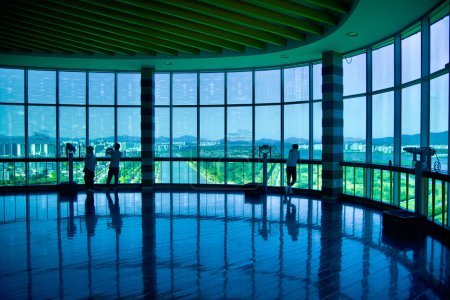 Photo for Hanam City, South Korea - October 1, 2023: Visitors inside the top deck of Hanam Union Tower enjoy a wide view of Misa Boat Race Park through the tall wraparound windows. - Royalty Free Image
