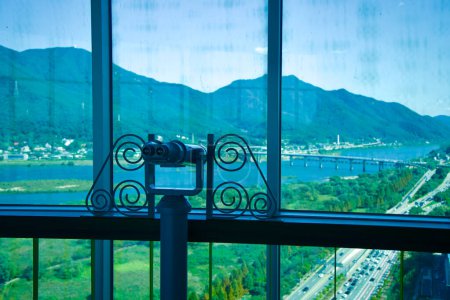 Photo for Hanam City, South Korea - October 1, 2023: From the viewing deck of Hanam Union Tower, mounted binoculars offer an enhanced view of Han River and Paldang Bridge in the background. - Royalty Free Image